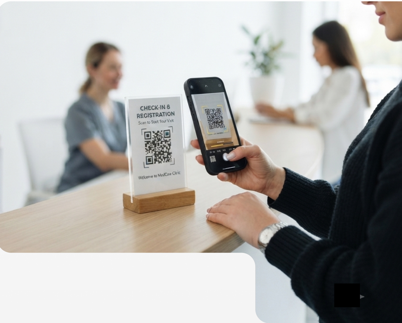 Patient checking in with a QR code at the front desk
